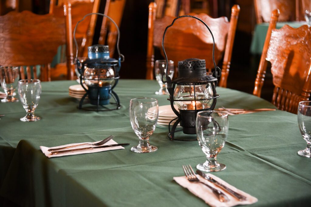 Photo of a set table at the Steaming Tender Restaurant with lanterns lit using tea light candles.